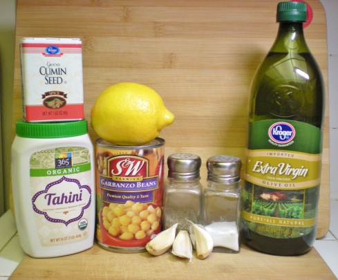 Hummus Ingredients L-R: Tahini, Ground Cumin, Lemon, Garbanzo Beans, Garlic, Pepper and Salt, Olive Oil